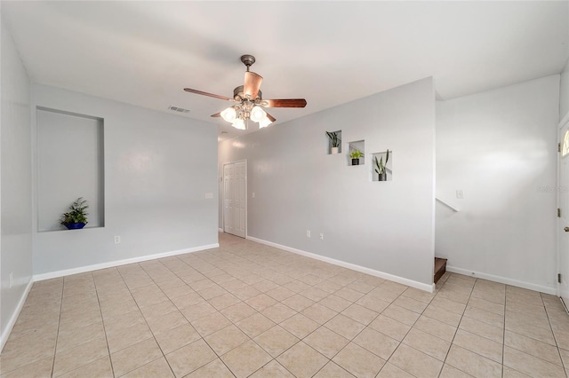 unfurnished room with ceiling fan and light tile patterned floors