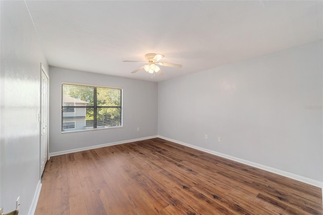 spare room with ceiling fan and wood-type flooring