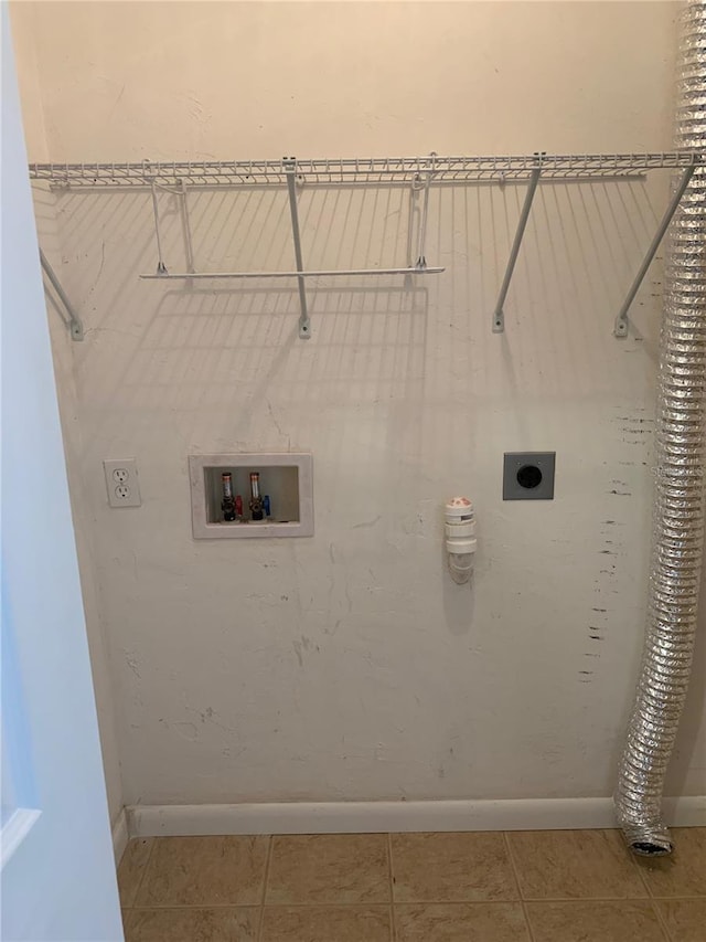 clothes washing area with electric dryer hookup, tile patterned flooring, and washer hookup