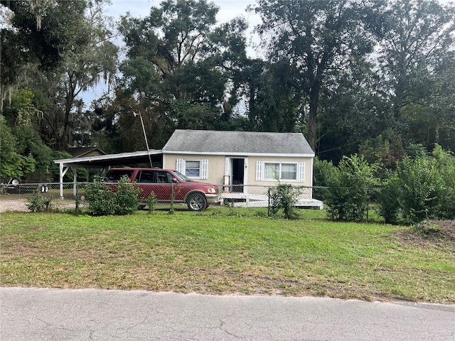 view of front of house with a front yard and a carport