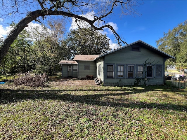 rear view of house with a yard