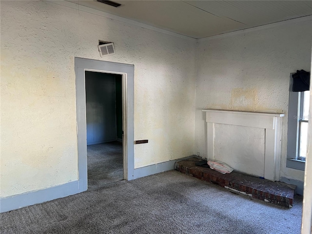 unfurnished living room featuring carpet, crown molding, and a fireplace