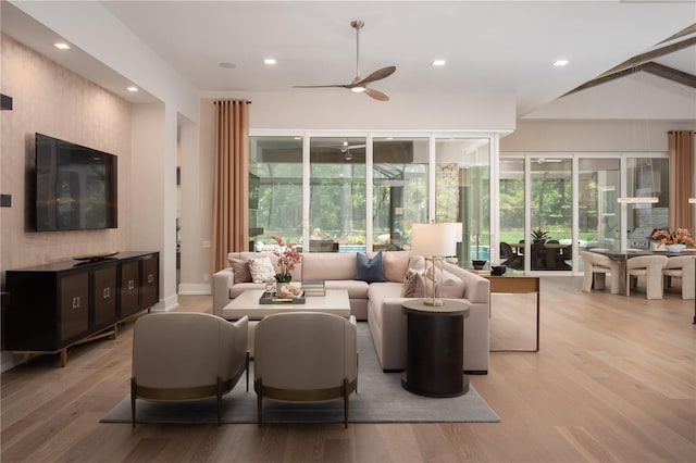 living room featuring ceiling fan and light hardwood / wood-style flooring