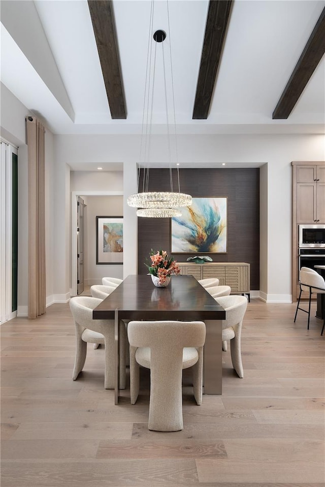 dining room with an inviting chandelier, light wood-type flooring, and beamed ceiling