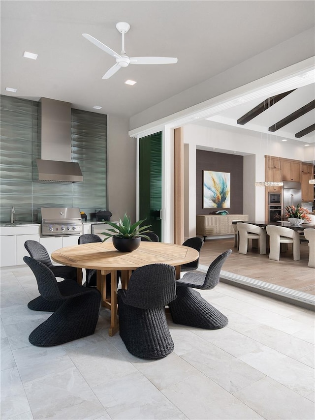 dining area with ceiling fan and sink