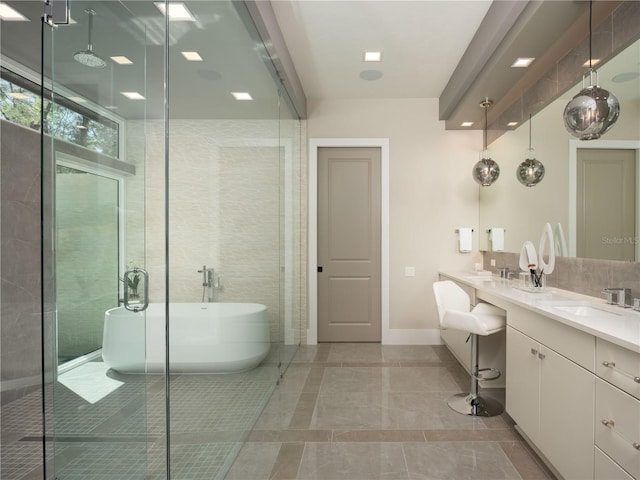 bathroom with plus walk in shower, tile patterned floors, and vanity