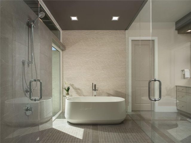 bathroom with tile walls, tile patterned flooring, and independent shower and bath