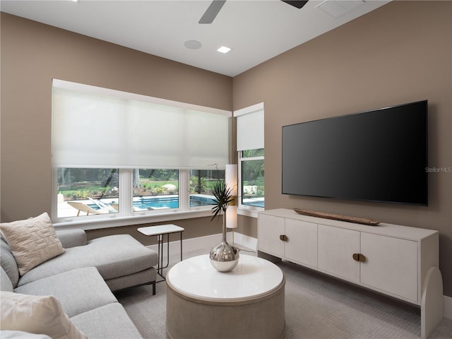 carpeted living room featuring ceiling fan