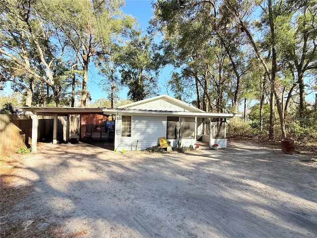 view of front of property with a carport and a sunroom