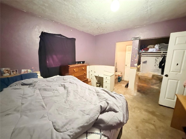 bedroom with a closet and a textured ceiling