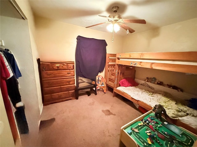 bedroom featuring ceiling fan and light carpet