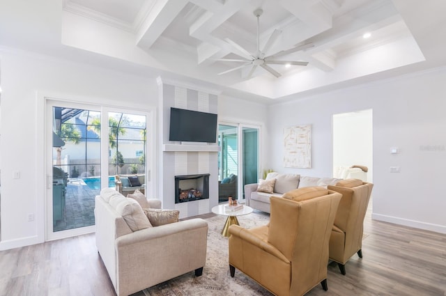 living room featuring a fireplace, light hardwood / wood-style flooring, ceiling fan, and coffered ceiling