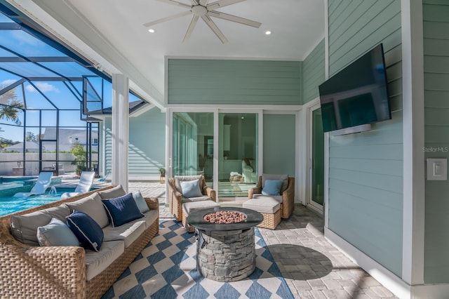 view of patio featuring a swimming pool, an outdoor living space with a fire pit, a lanai, and ceiling fan