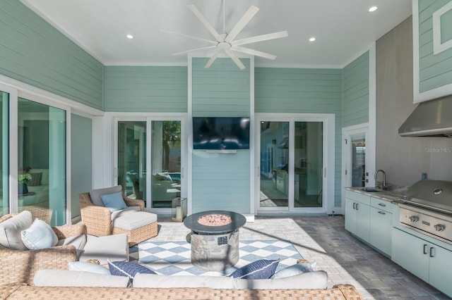 view of patio with a grill, ceiling fan, sink, and an outdoor fire pit