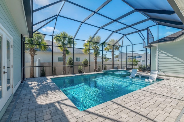 view of pool featuring an in ground hot tub, pool water feature, a patio area, and a lanai