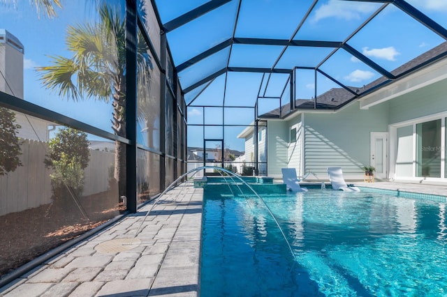 view of pool featuring glass enclosure and pool water feature