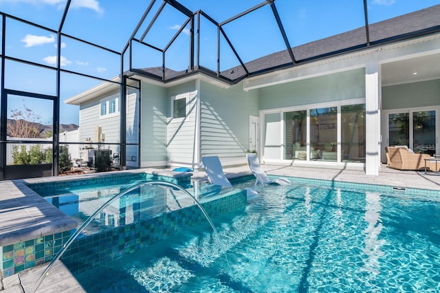 view of swimming pool featuring pool water feature, glass enclosure, and a patio