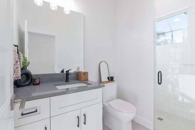 bathroom with vanity, toilet, and walk in shower