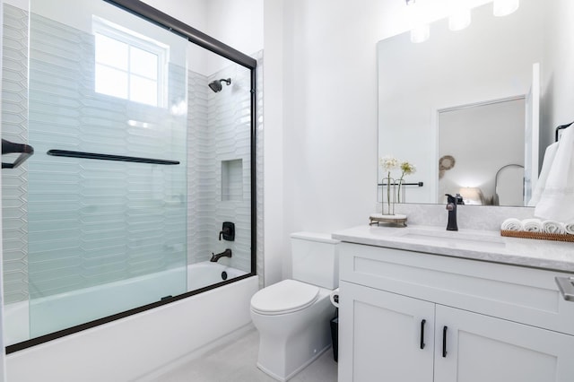 full bathroom featuring shower / bath combination with glass door, vanity, and toilet