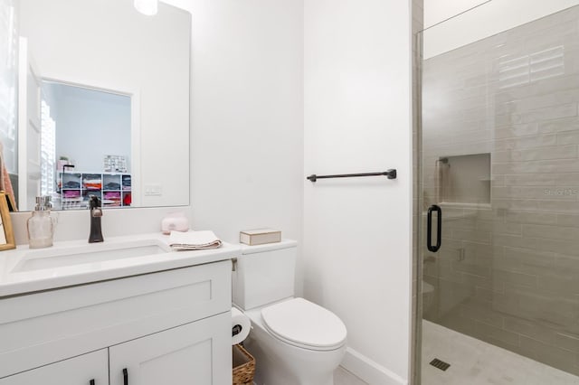 bathroom with vanity, toilet, and an enclosed shower