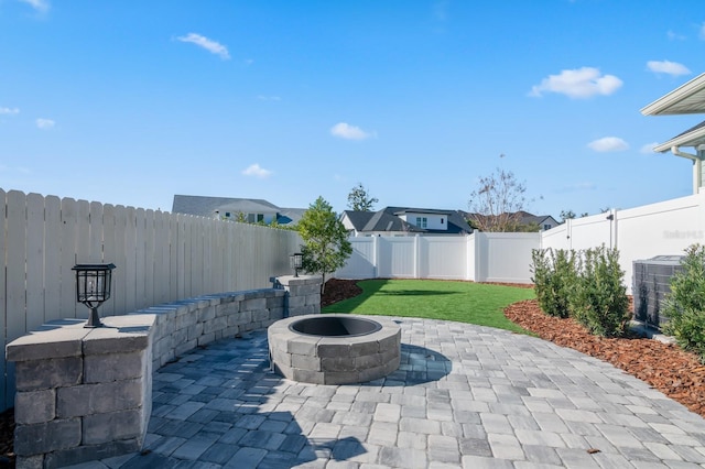 view of patio / terrace with central AC unit and an outdoor fire pit