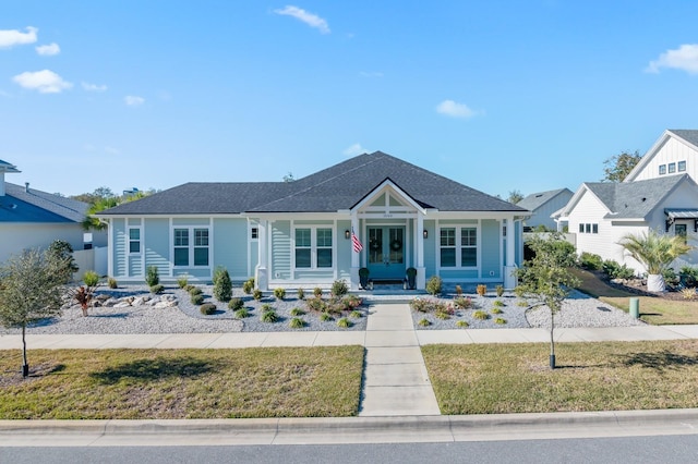 view of front of home featuring french doors and a front lawn