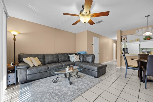 tiled living room with ceiling fan