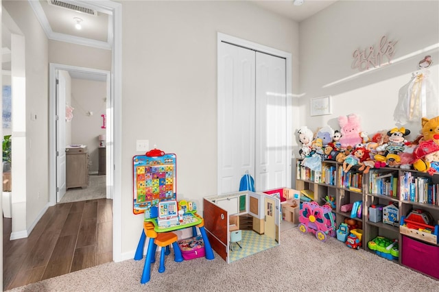 game room with dark carpet and crown molding