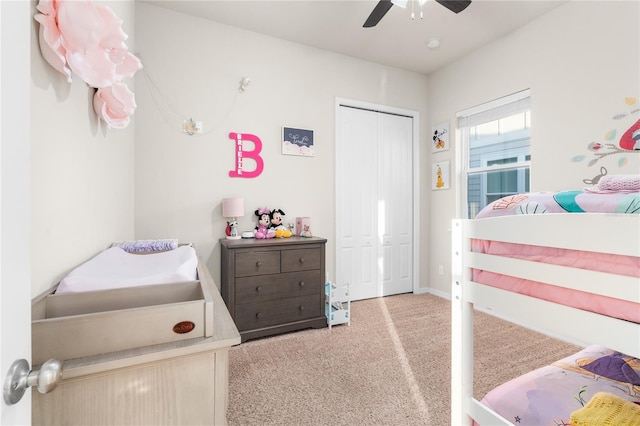 carpeted bedroom featuring ceiling fan and a closet