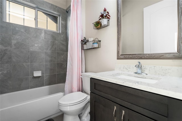 full bathroom featuring vanity, shower / tub combo, and toilet