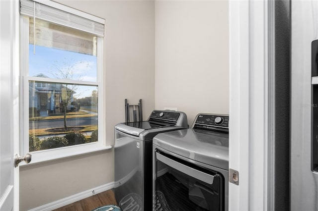 laundry room featuring hardwood / wood-style floors and washer and dryer