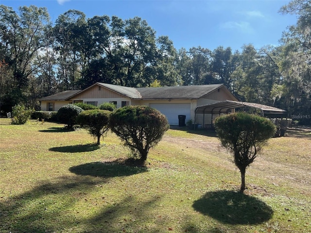 view of home's exterior featuring a carport, a garage, and a yard