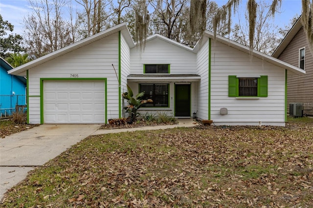 view of front of home featuring central AC unit and a garage