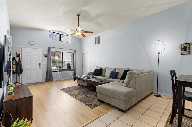 living room with ceiling fan, light hardwood / wood-style flooring, and lofted ceiling