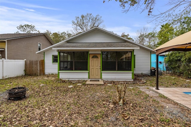 bungalow-style house with a gazebo and a fire pit