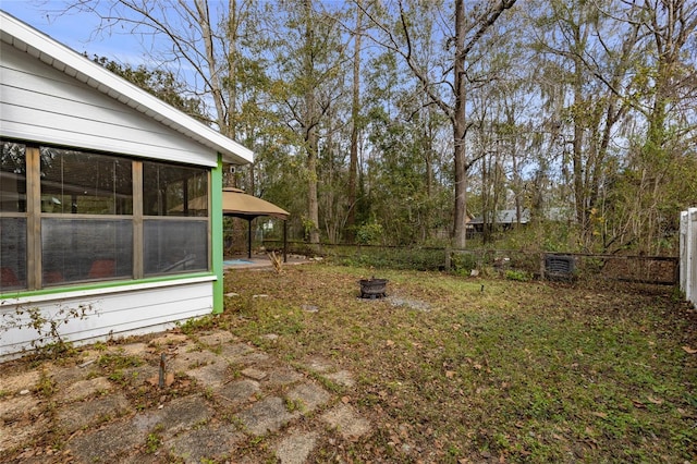 view of yard with a fire pit and a sunroom