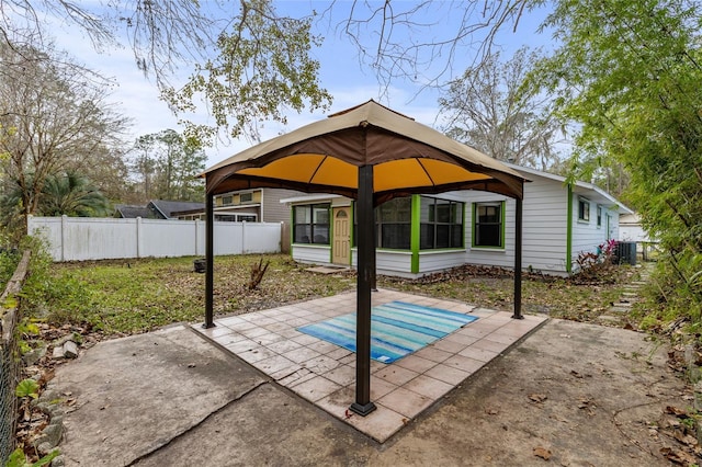 back of property featuring a gazebo and a patio area