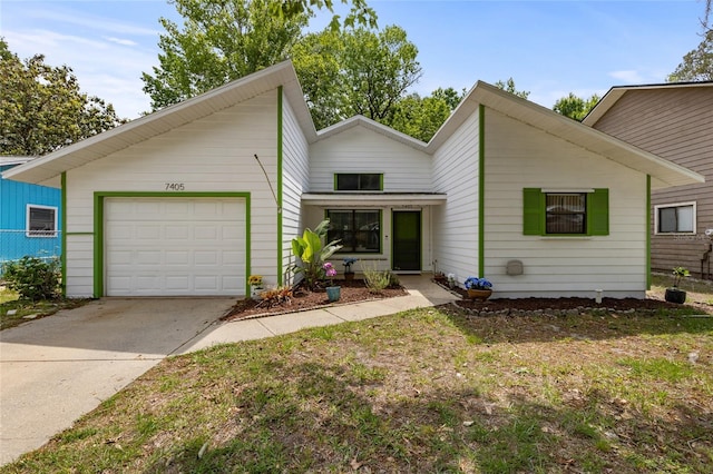 7405 NW 21st Way, Gainesville, FL 32653 - mid-century modern home featuring concrete driveway and a garage