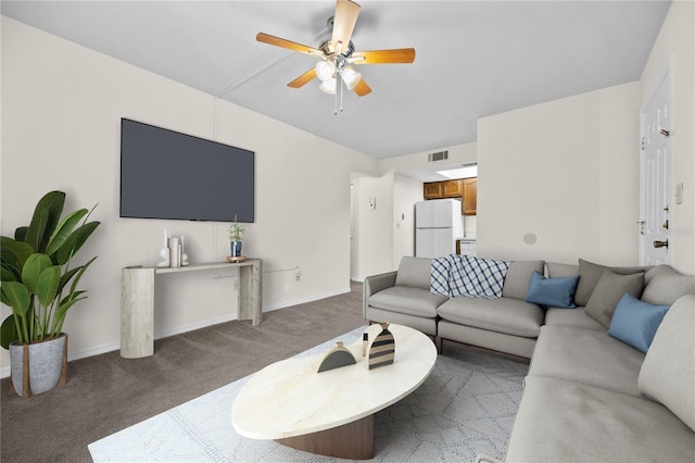 living room featuring ceiling fan and dark carpet