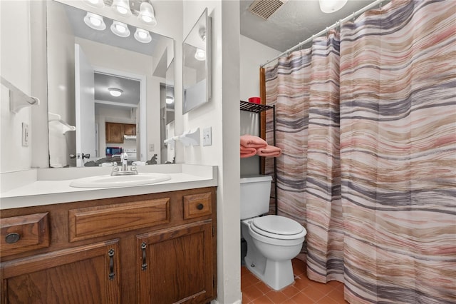 bathroom featuring tile patterned floors, vanity, and toilet