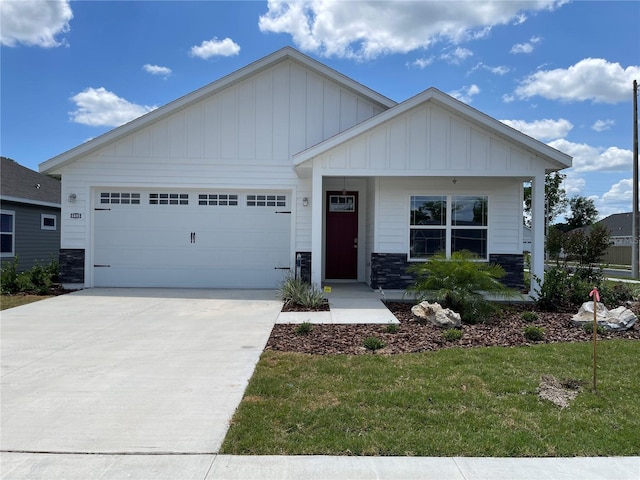 view of front of house featuring a porch, a garage, and a front lawn