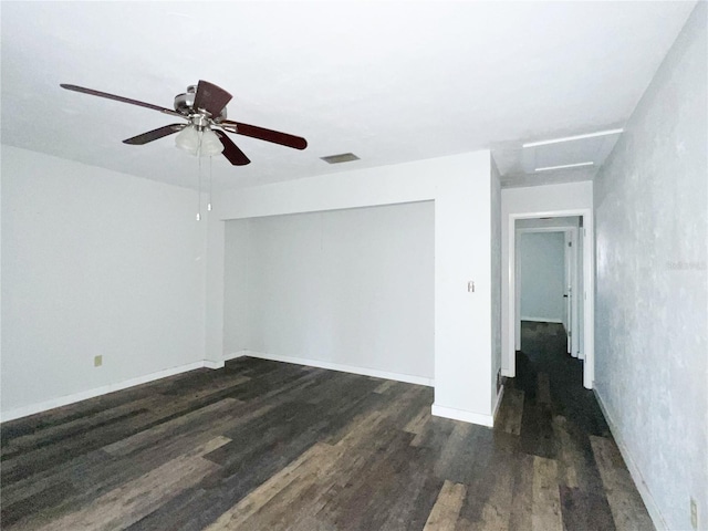 unfurnished room with dark hardwood / wood-style flooring