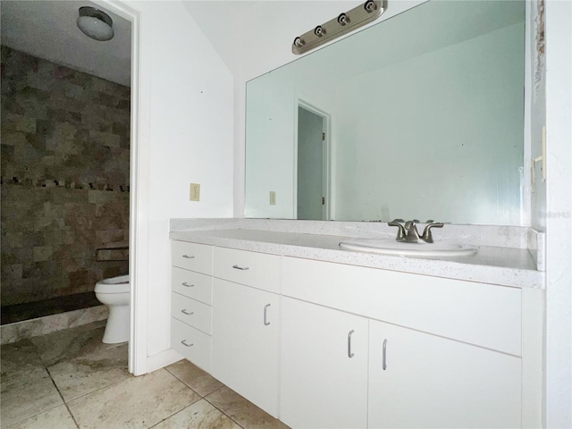 bathroom featuring vanity, walk in shower, and toilet