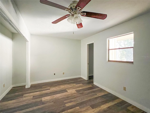 unfurnished bedroom featuring dark wood-type flooring, ceiling fan, and a closet