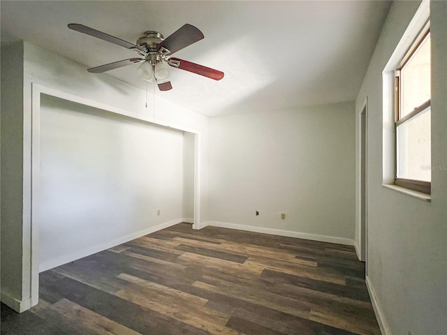 unfurnished room with dark wood-type flooring and ceiling fan