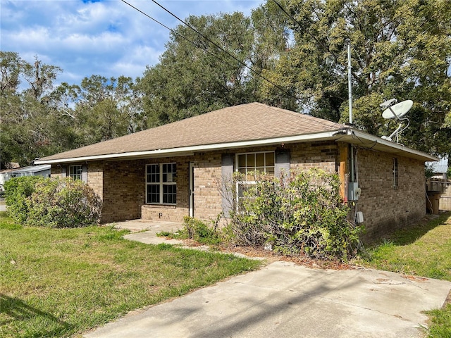 single story home featuring a patio area and a front lawn