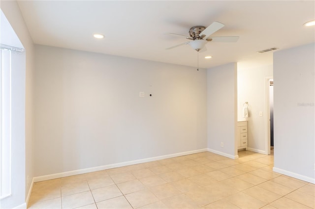 unfurnished room featuring light tile patterned floors and ceiling fan