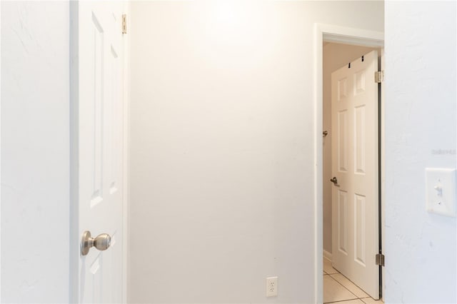 corridor featuring light tile patterned flooring