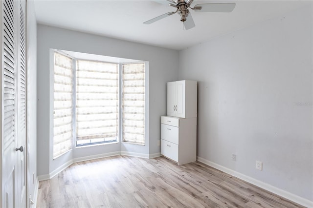 unfurnished bedroom featuring ceiling fan, light hardwood / wood-style floors, and a closet