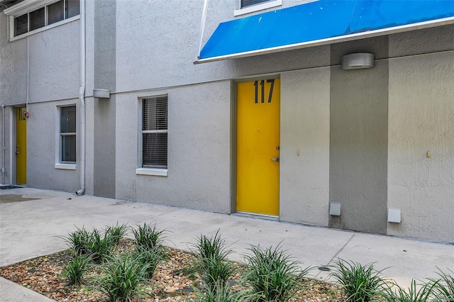 doorway to property with a patio area